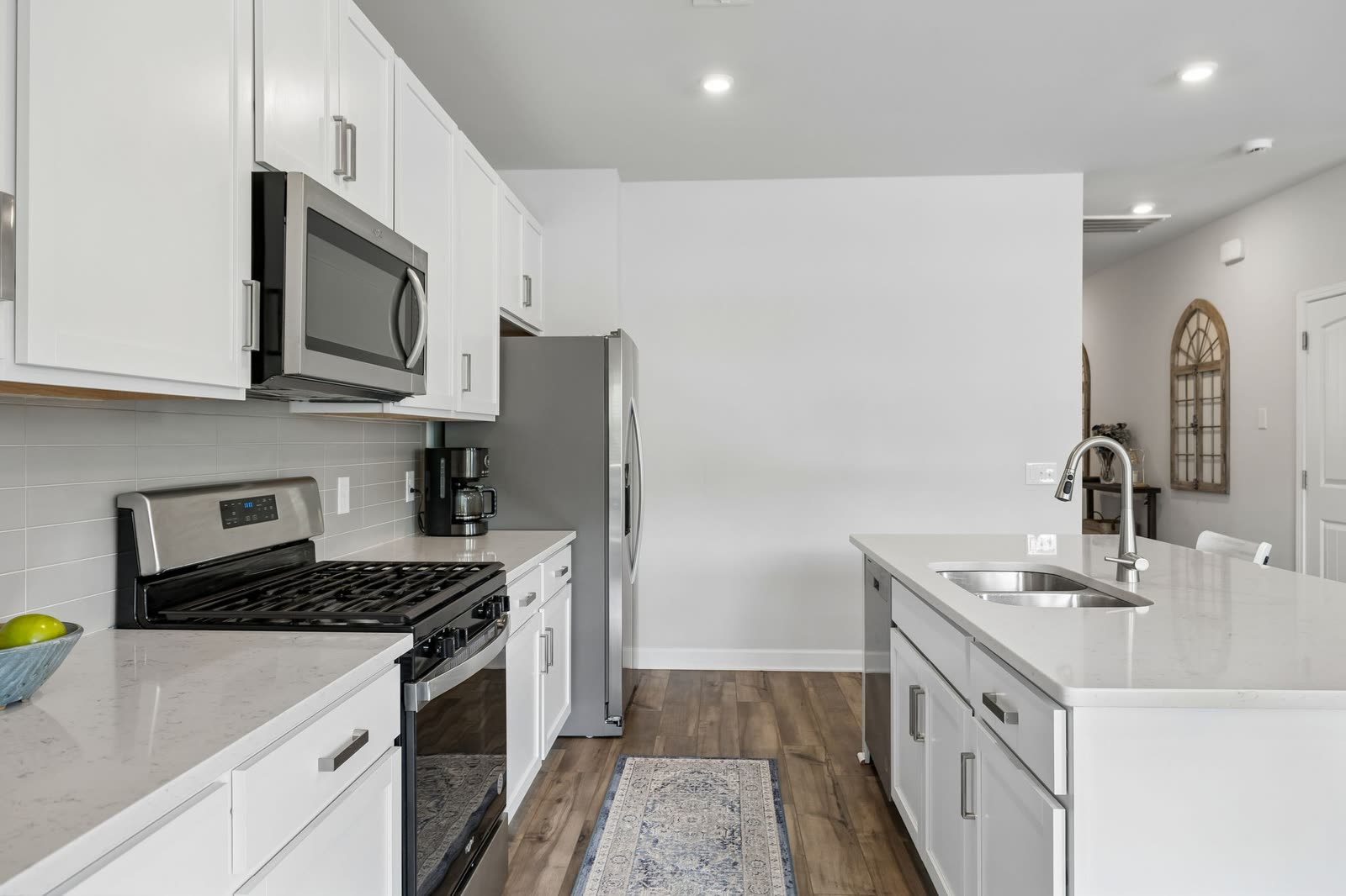 Kitchen with island, quartz counters and gas range at 123 Millbrook Drive