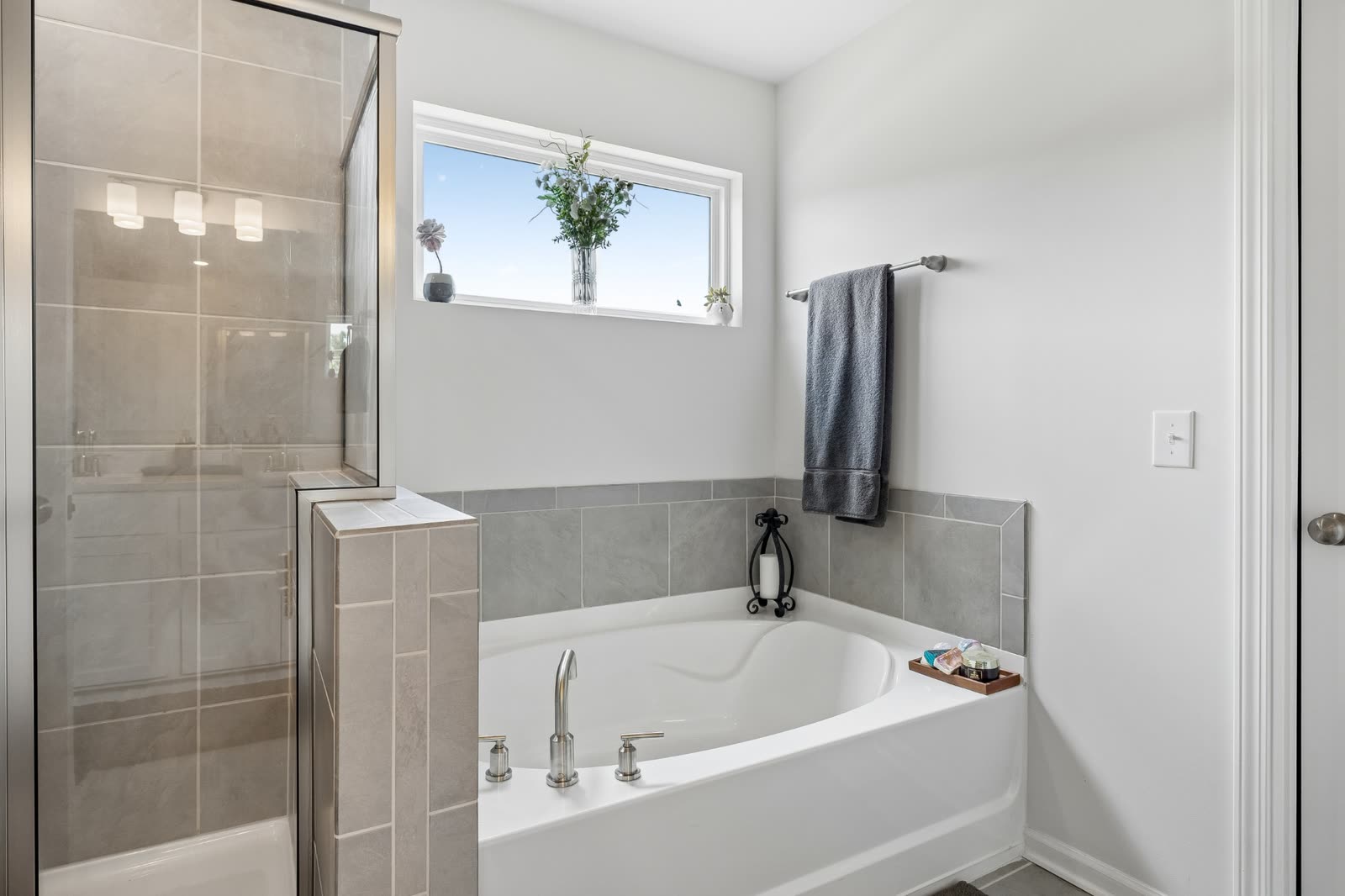 Primary bath with soaking tub and separate tiled shower at 123 Millbrook Drive